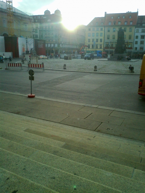 At the stairs of Oper München, Sunset behind the towers of the Frauenkirche