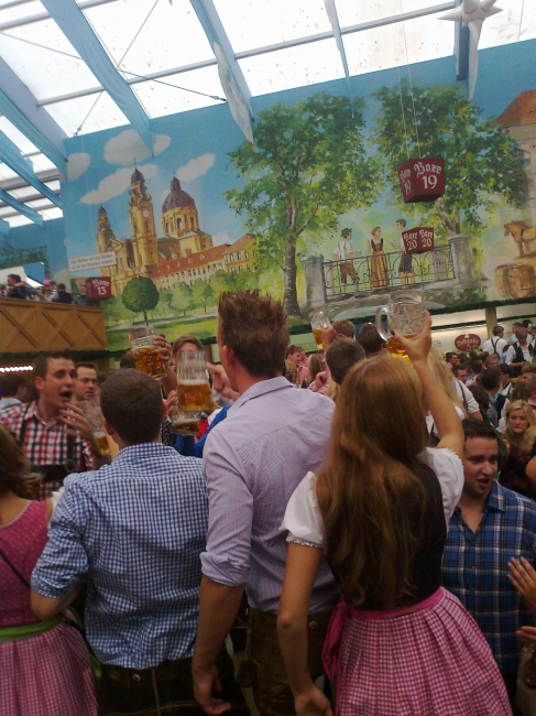People partying hard, at the Hacker-Pschorr beer tent on the Oktoberfest Wiesn