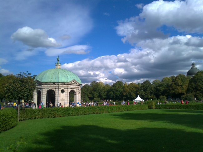Hofgarten pavillion, green lawn and blue skies above Munich