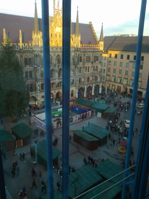 Marienplatz with booths, preparing for Christmas market, a bit of late afternoon sun glow on the Neues Rathaus