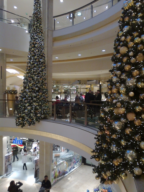 Kö-Arkaden, newly refurbished, with Christmas Trees, dm below, doing some kind of promotion with girls in white coats