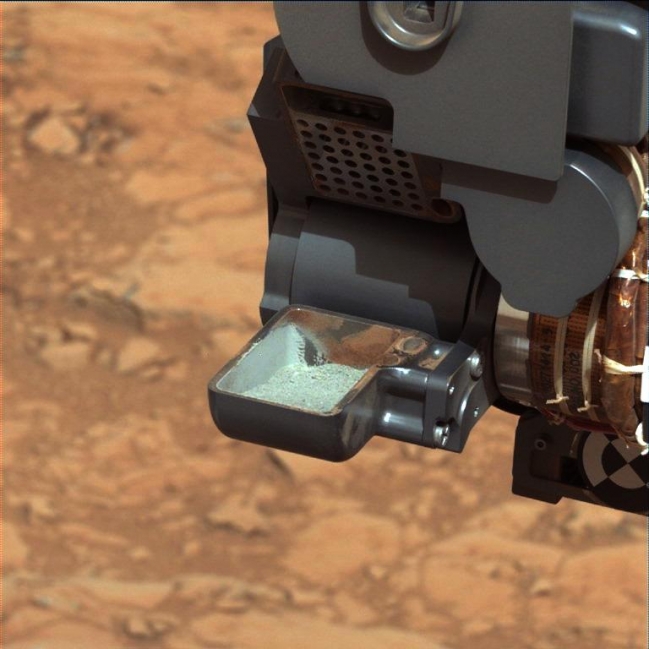 First Curiosity Drilling Sample in the Scoop, Raw version Click on the image for larger version This image from NASA's Curiosity rover shows the first sample of powdered rock extracted by the rover's dri...
