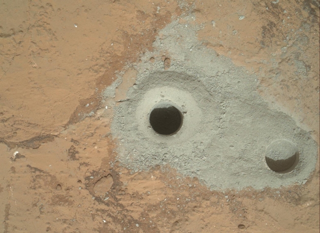 Curiosity's First Sample Drilling, At the center of this image from NASA's Curiosity rover is the hole in a rock called "John Klein" where the rover conducted its first sample drilling on Mars...