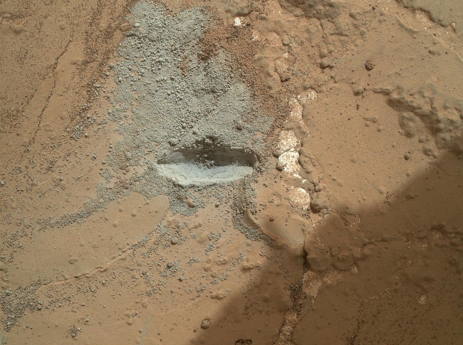 Preparatory Test for First Rock Drilling by Mars Rover Curiosity, The bit in the rotary-percussion drill of NASA's Mars rover Curiosity left its mark in a target patch of rock called "John Klein" during a test on the rover'...