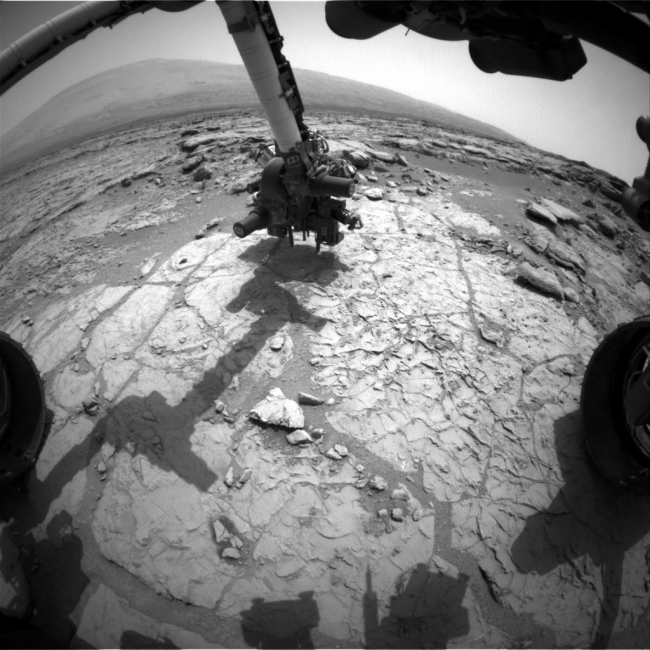 Curiosity's Drill in Place for Load Testing Before Drilling, The percussion drill in the turret of tools at the end of the robotic arm of NASA's Mars rover Curiosity has been positioned in contact with the rock surface...