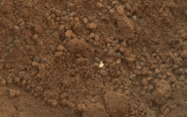 Bright Particle in Hole Dug by Scooping of Martian Soil, This image shows part of the small pit or bite created when NASA's Mars rover Curiosity collected its second scoop of Martian soil at a sandy patch called "R...