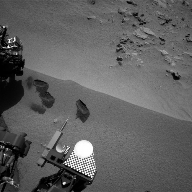 Curiosity's First Three Bites Into Martian Ground, Three bite marks left in the Martian ground by the scoop on the robotic arm of NASA's Mars rover Curiosity are visible in this image taken by the rover's rig...