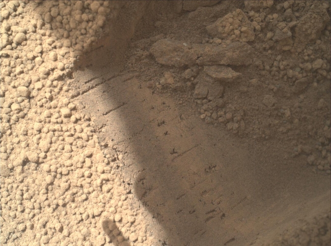 Bright Particle of Martian Origin in Scoop Hole, This image contributed to an interpretation by NASA's Mars rover Curiosity science team that some of the bright particles on the ground near the rover are na...