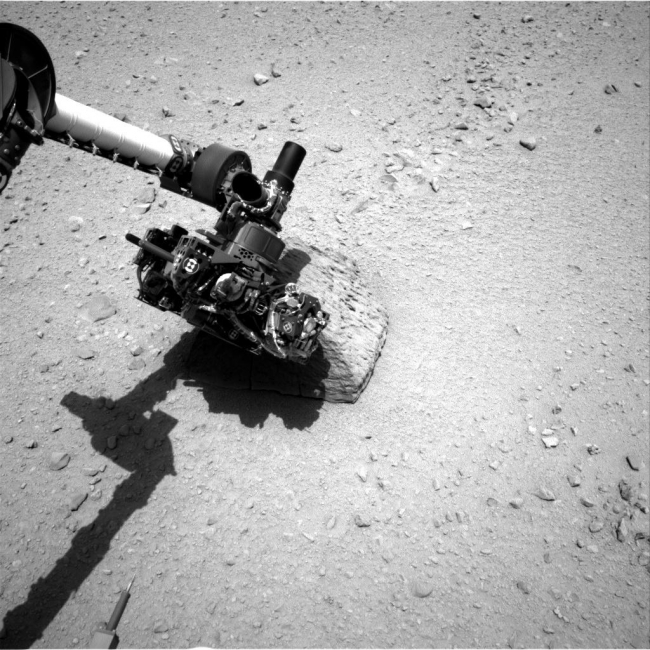 Curiosity's Rock-Contact Science Begins, This image shows the robotic arm of NASA's Mars rover Curiosity with the first rock touched by an instrument on the arm. The rover's right Navigation Camera ...