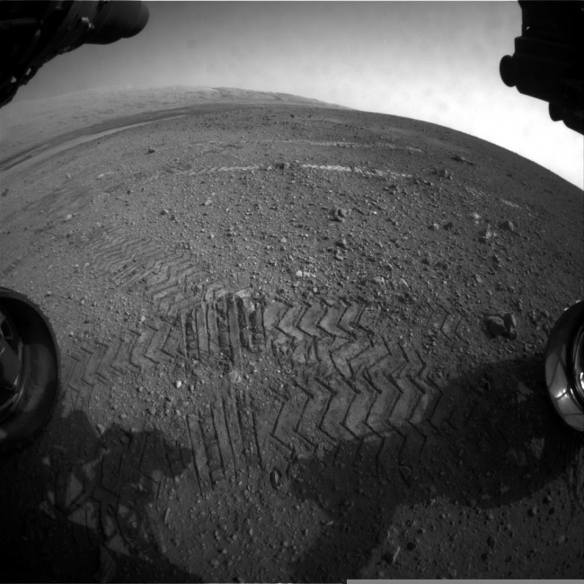 Big Wheels Keep on Rollin', This image taken by a front Hazard-Avoidance camera on NASA's Curiosity shows track marks from the rover's first Martian drives. The rover's Bradbury Landing...