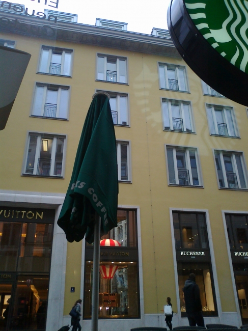 Full view of the facade of the building at Opernplatz, which is home to Louis Vuitton, Bucherer and other premium stores, from Starbuck's, obviously