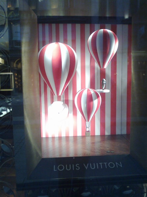Balloons in a window of Louis Vuitton's, 