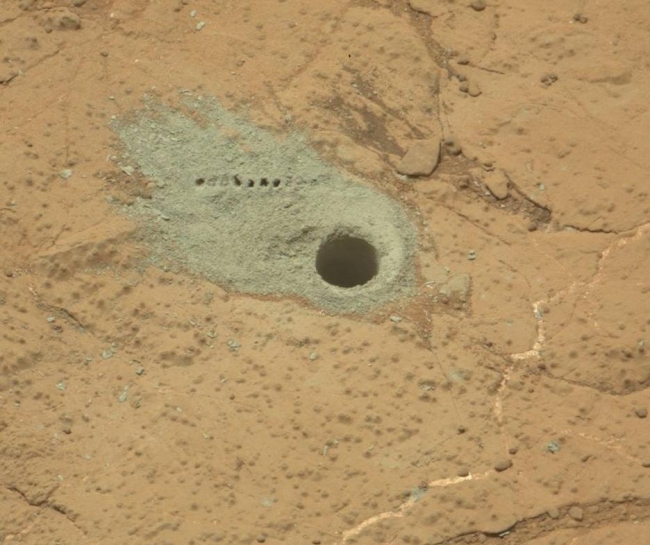 Drilled Hole and ChemCam Marks at 'Cumberland', The Chemistry and Camera (ChemCam) instrument on NASA's Mars rover Curiosity was used to check the composition of gray tailings from the hole in rock target ...
