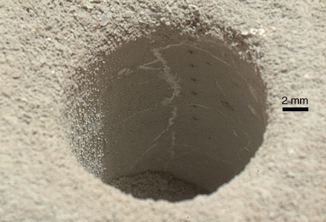 View into 'John Klein' Drill Hole in Martian Mudstone, The hole that NASA's Curiosity Mars rover drilled into target rock "John Klein" provided a view into the interior of the rock, as well as obtaining a sample ...
