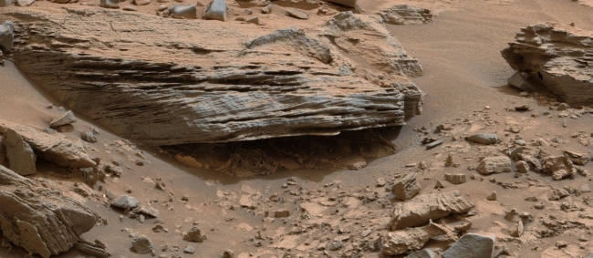 Martian Rock's Evidence of Lake Currents, Figure 1 Click on the image for larger version Cross-bedding seen in the layers of this Martian rock is evidence of movement of water recorded by waves or ri...