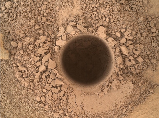 First Sampling Hole in Mount Sharp, This image from the Mars Hand Lens Imager (MAHLI) camera on NASA's Curiosity Mars rover shows the first sample-collection hole drilled in Mount Sharp, the la...