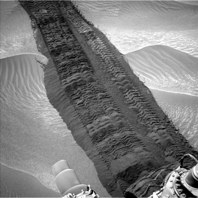 Curiosity Tracks in 'Hidden Valley' on Mars, This image from the Navigation Camera on NASA's Curiosity Mars rover shows wheel tracks printed by the rover as it drove on the sandy floor of a lowland call...