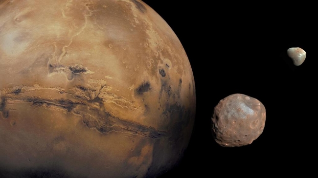 The Moons of Mars, Mars is kept company by two cratered moons -- an inner moon named Phobos and an outer moon named Deimos. On August 1, 2013, NASA's Curiosity rover pointed it...