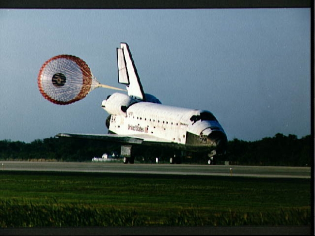 The Shuttle orbiter landing, with the brake parachute deployed
