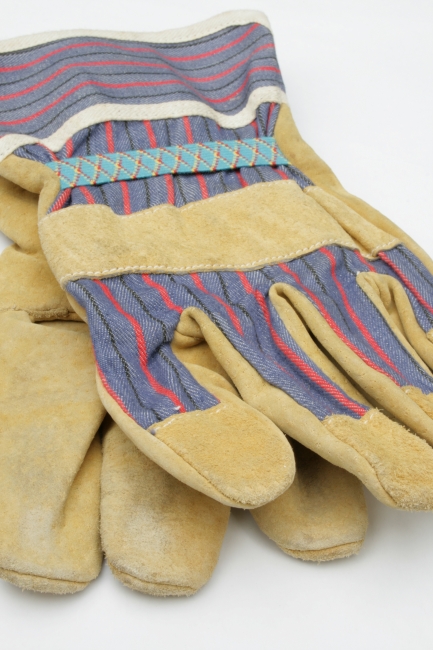 Pair of work gloves on white, Pair of worker gloves, lightly used and nearly new on plain white background, slight bukeh in the background