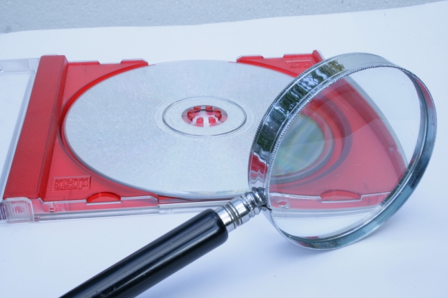 A magnifier and a CD, compact disk and magnifying glass