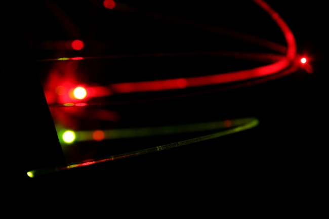 Fiber optic cables red and green, Two fiber optic cables, the upper red, the lower green, the lower in crisp focus.