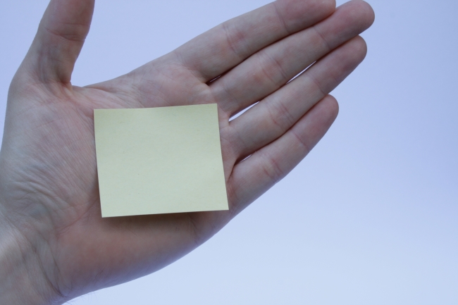 Post-it on hand, A yellow post-it note paper placed on an opened hand