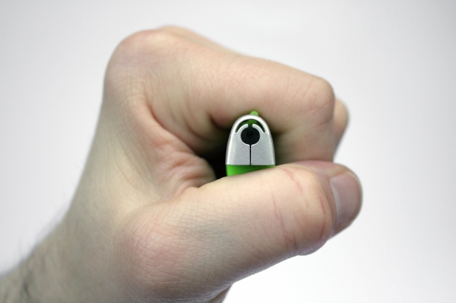 Cigarette lighter in hand, A hand/ fist holding a green and silver cigarette lighter, directing the gas nozzle towards the camera as in a top-down view, the hand pressing the trigger, ...