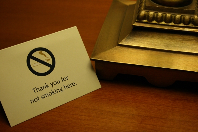 Thank you for not smoking, A sign on a hotel room desk saying 'Thank you for not smoking here', at night