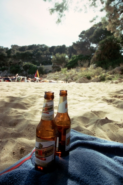 San Miguel bottles on the beach of Cala Gat, 