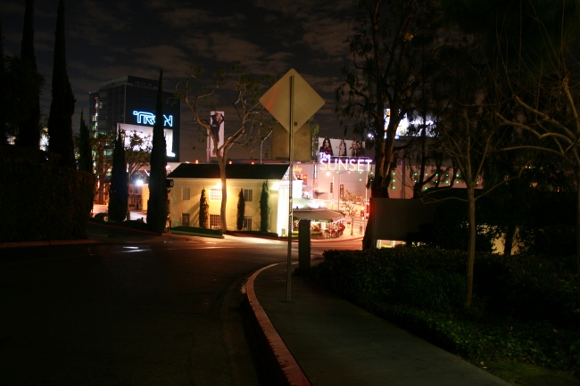 W Sunset Blvd seen from Sunset Plaza Drive at night, The giant TRON billboard and "The Sunset" Sunset Plaza mall