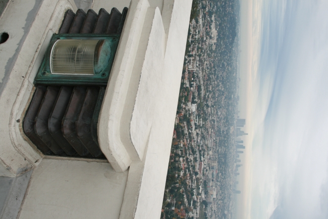 A lamp detail on Griffith Park Observatory, and in the background, part of the Los Angeles basin with Downtown in center