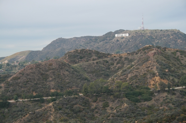 The Hollywood sign as seen from Griffith Park Observatory, in dim evening sunlight