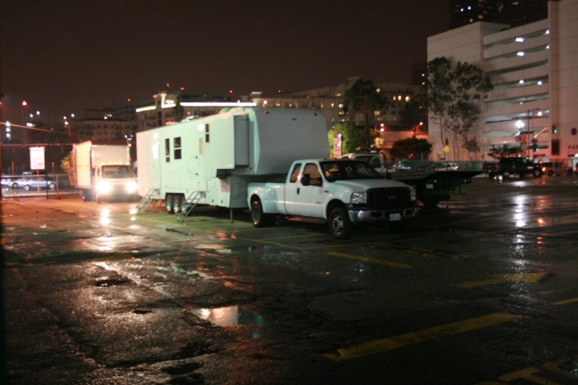 Film trucks and trailers in Downtown L.A. at night, 