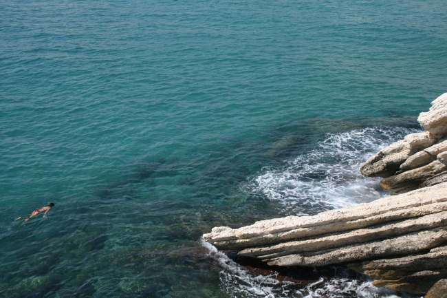 Swimmer at the rocks of the Castel, 