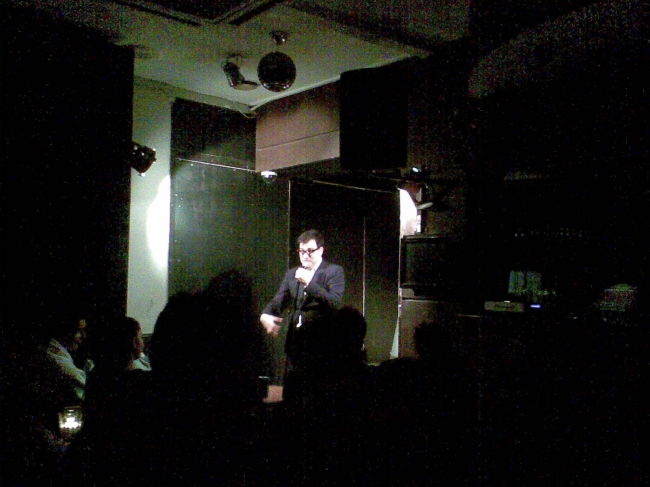 Stand up comic performance, in a SoHo basement club