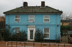 A cyan house, near a c...