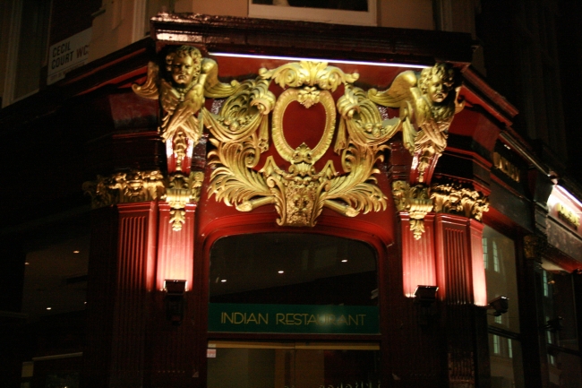 Golden crest on an Indian Restaurant door, Cecil Court, WC