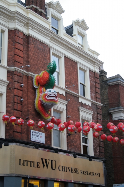 A big dragon-lion-tiger on a house's facade, 