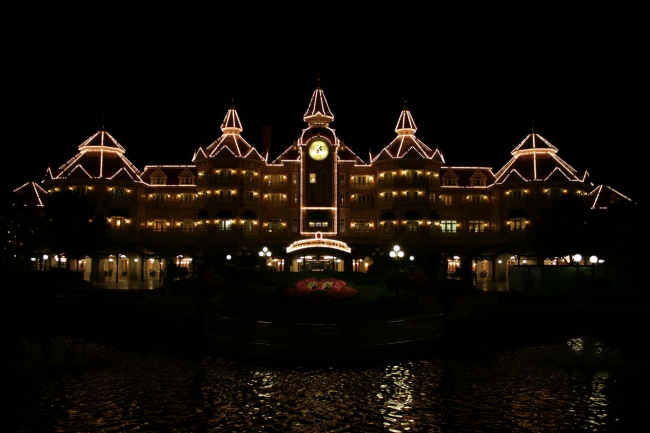 Disneyland Paris main entry and Disneyland Hotel, at night