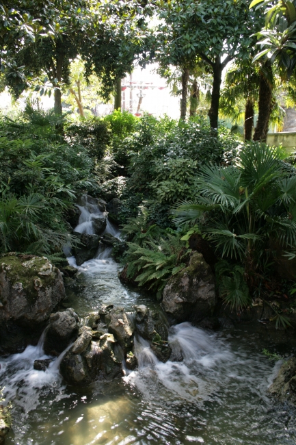 The pond / waterfall at the gate to Fantasyland, the last thing you can see when leaving Adventureland over the wood gate