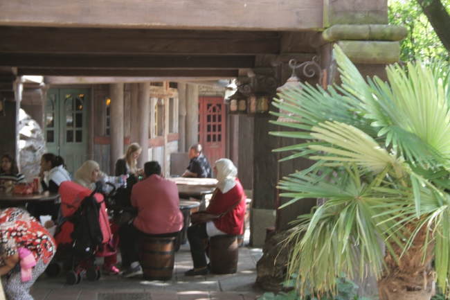 People eating, at the Chalet de la Marionnette near the intersection to Adventureland