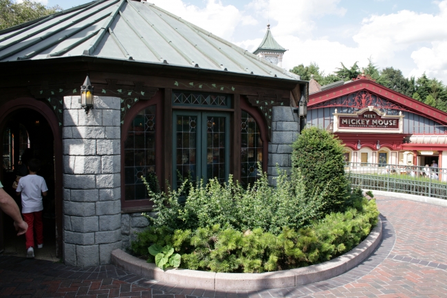 Toad Hall restaurant dining area, medievally styled, with Meet Mickey Mouse in the background