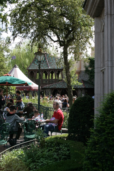 In front of Toad Hall, looking towards peter Pan (I guess), people dining in the foreground