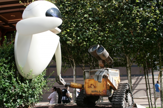 Wall-E and EVE holding hands near Space Mountain, 